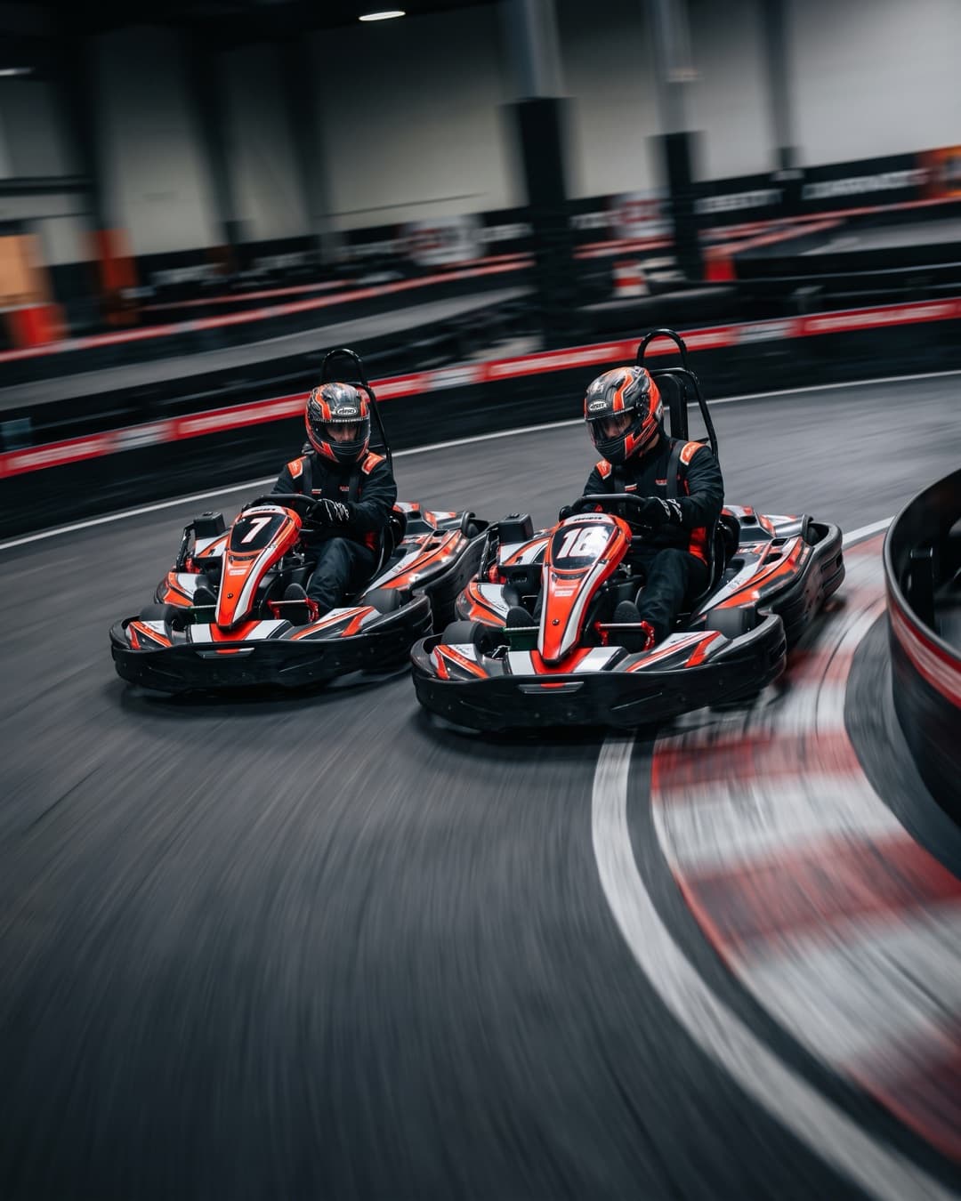 Karts in der Kurve einer Indoor-Strecke während eines privaten Einstundenrennens